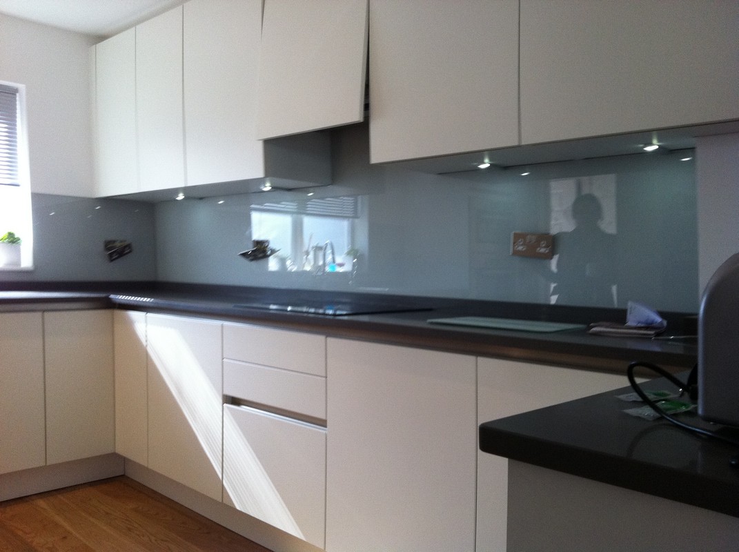Grey glass kitchen splashback with LED lighting in Hampstead